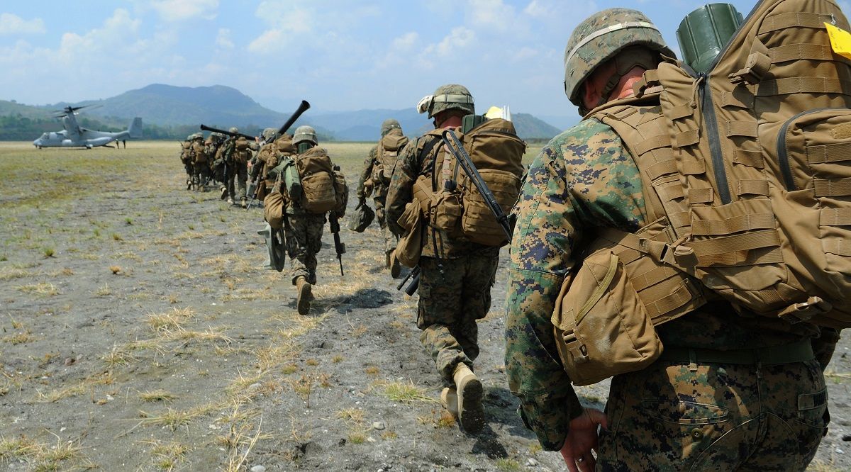 US Marines carrying heavy gear in a loaded march
