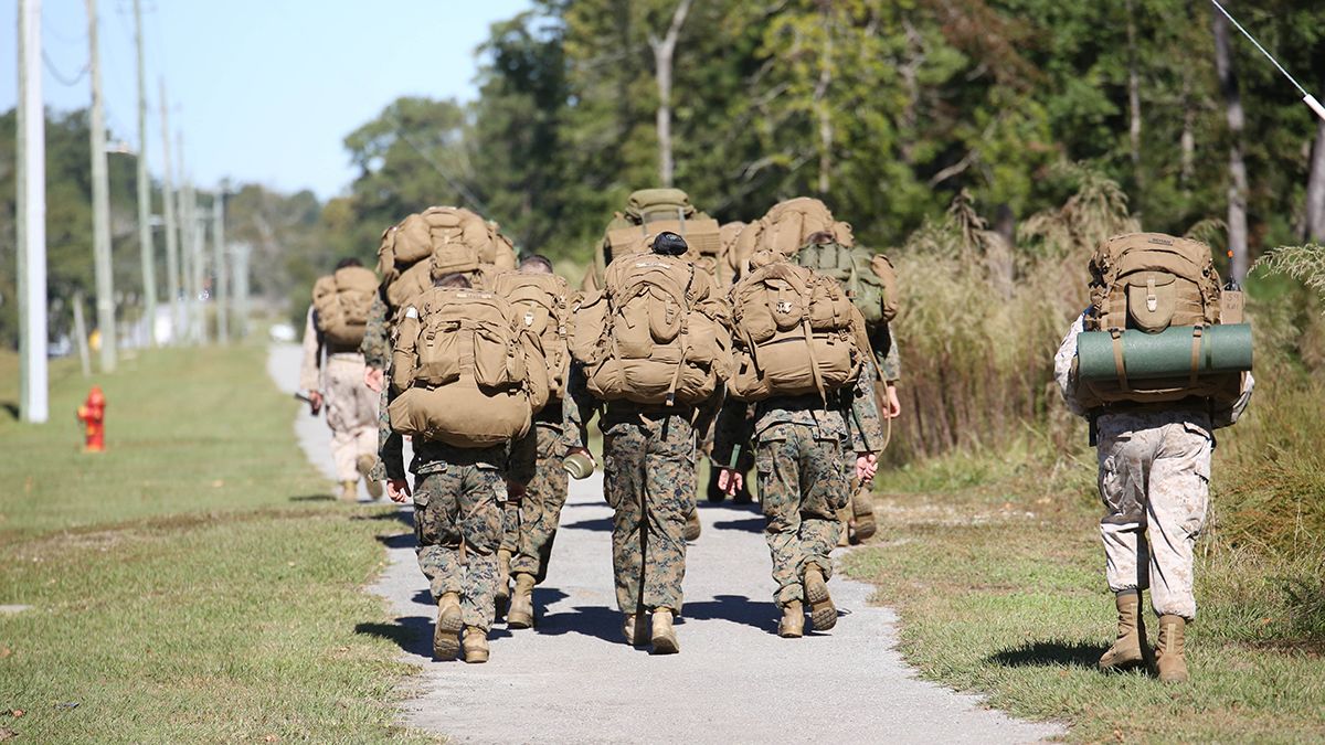 sniper trainees marching with large ruck sacks