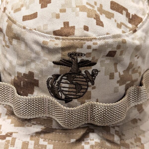 an embroidered US Marine Corps Eagle, Globe, & Anchor emblem on a desert MARPAT boonie cover