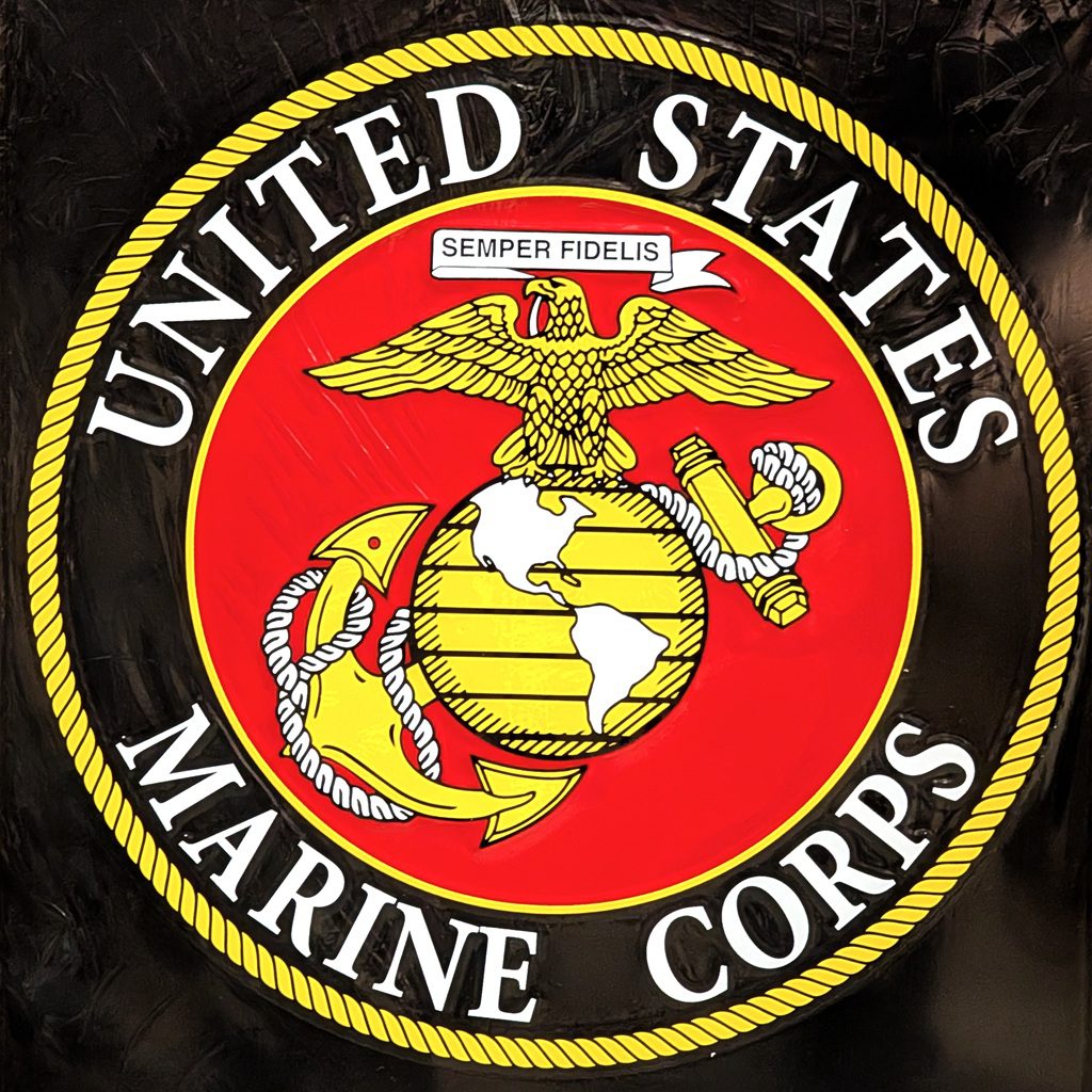 a US Marine Corps parking sign featuring the USMC logo and "PARKING ONLY"