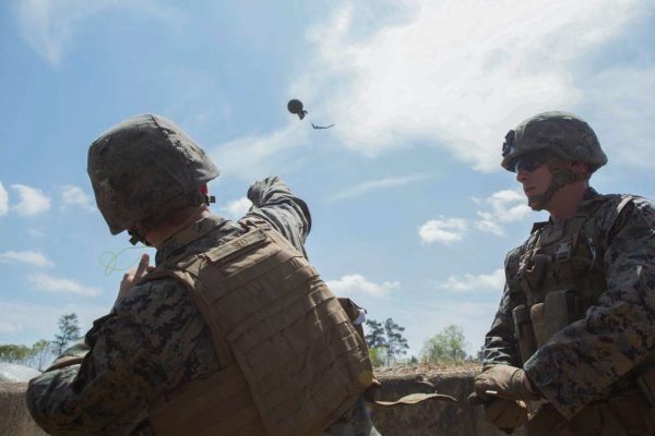 A Marine throws a M67 frag grenade during combat training
