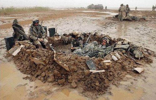 U.S. Marines deployed for Operation Iraqi Freedom get some much needed rest despite the weather conditions.