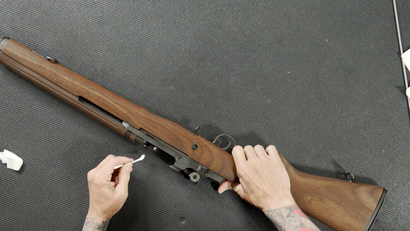 Cleaning Rifle with Cotton Swab