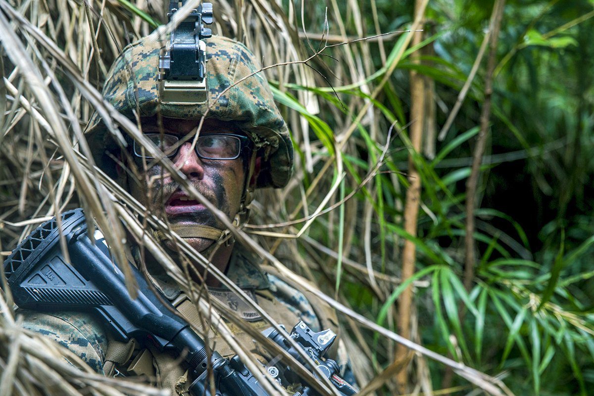 Marine blending into jungle with facepaint