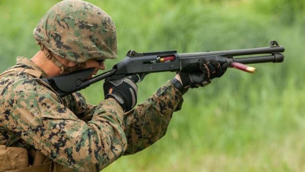 A US Marine firing a shotgun