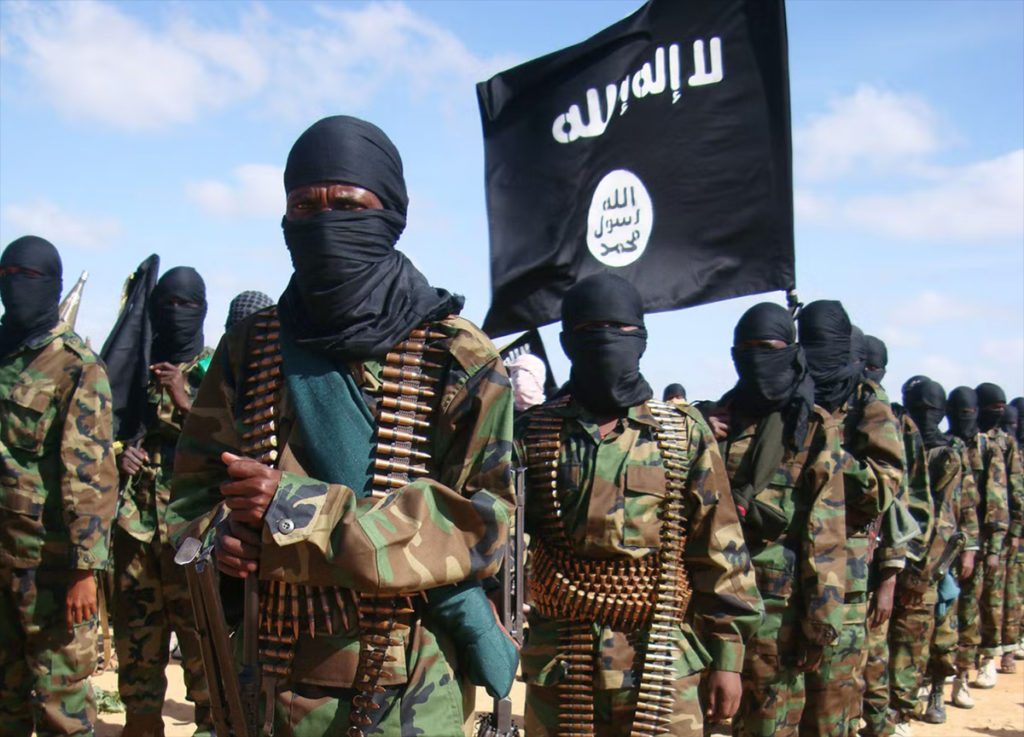 soldiers of Al Shabab wearing masks and carrying flag