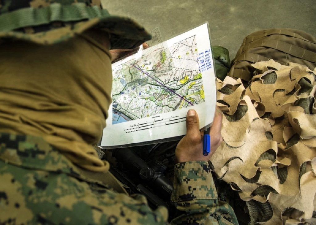 A US Marine studies a map, a feature of maneuver warfare