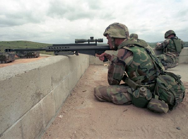 a Marine sniper wearing a woodland camo Kevlar flak jacket