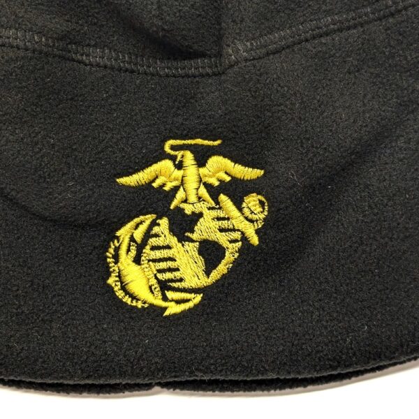 a black fleece watch cap with a gold embroidered Marine Corps EGA