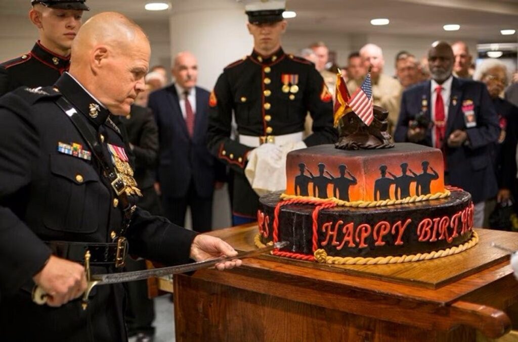 cutting the Marine Corps birthday cake with an officer sword