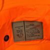 the tag of a government contractor issued hunter orange water resistant type II jungle hat