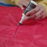 applying seam sealant to a leaky tent seam