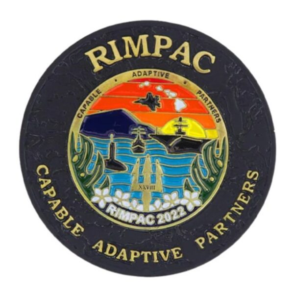 a matte black challenge coin with a colorful maritime warfare exercise and the words "RIMPAC" and "Capable, Adaptive, Partners."