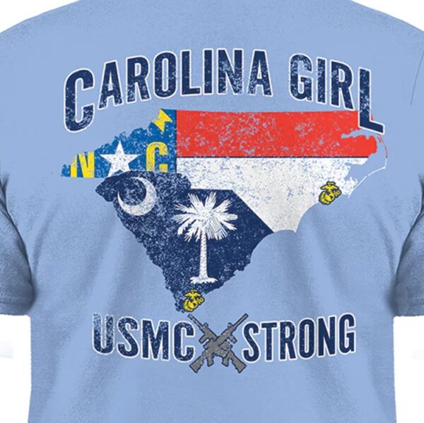 a closeup of a sky blue shirt that says "CAROLINA GIRL" "USMC STRONG" and features North Carolina and South Carolina