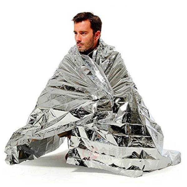 a man wearing a mylar emergency blanket