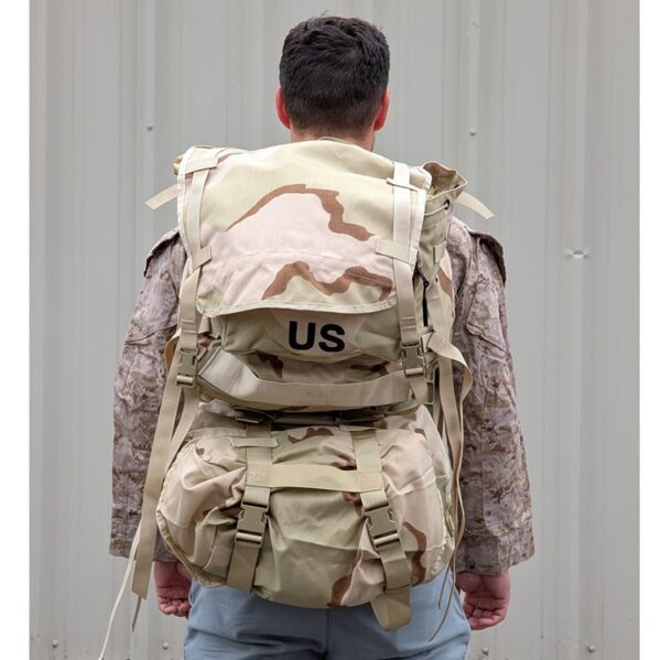 a Marine wearing a desert MARPAT FROG combat shirt wears a 3-color desert USGI MOLLE II Large Ruck Sack