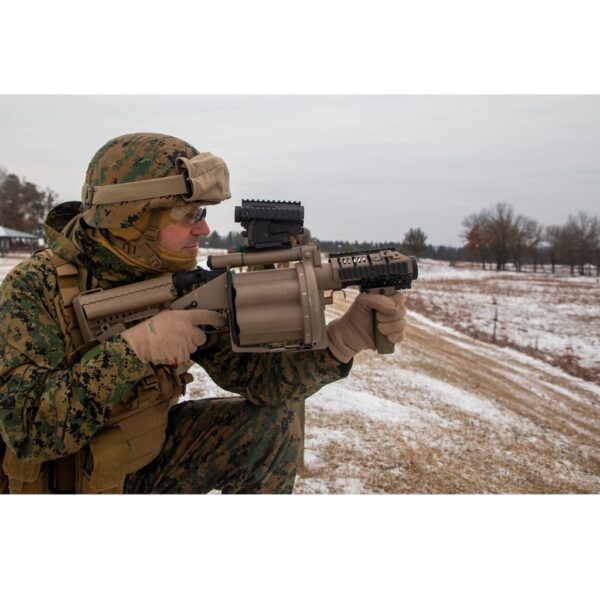 a Marine aims an M32 grenade launcher