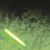 a green 12-hour light stick illuminates a map in the dark
