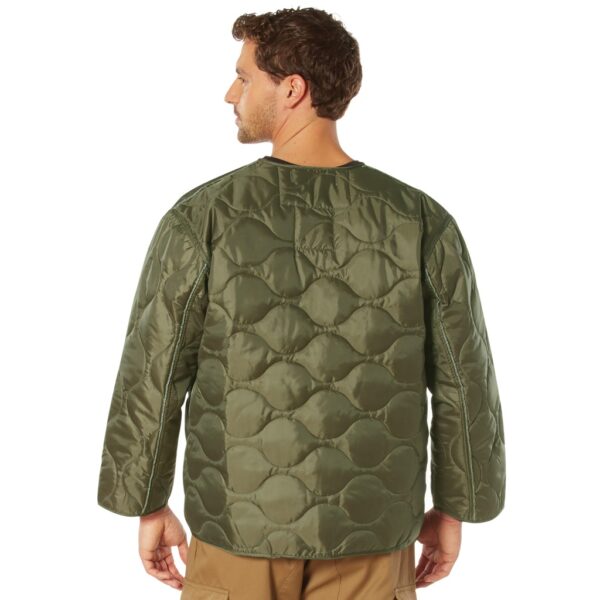 man wearing an olive drab military field jacket liner