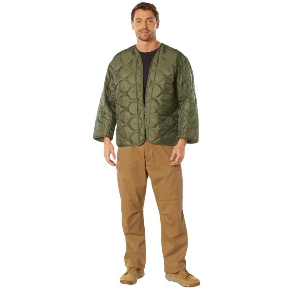 man wearing an olive drab military field jacket liner