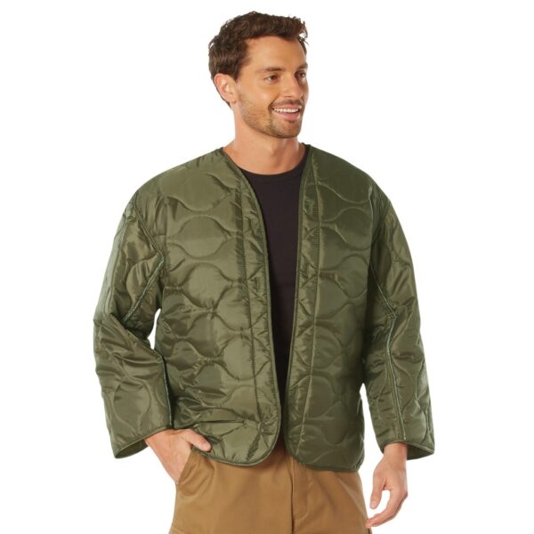 man wearing an olive drab military field jacket liner