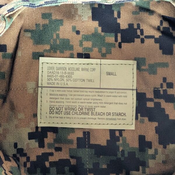 the tag on a woodland MARPAT camouflage 8-point utility cover (garrison cap) for the US Marine Corps Young Marines