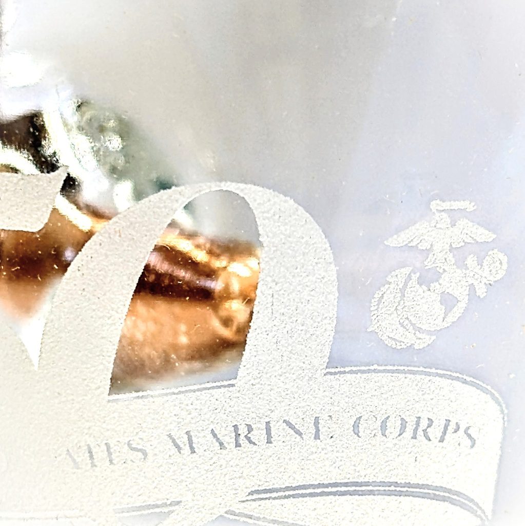 a US Marine Corps 250th anniversary shot glass with a 308 bullet embedded into it
