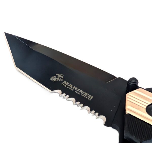 a black pocket knife with gold highlights with a US Marine Corps seal and a serrated blade with a tanto tip