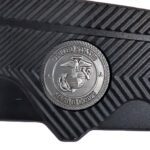 a black pocket knife with gold highlights with a US Marine Corps seal and a serrated blade with a tanto tip
