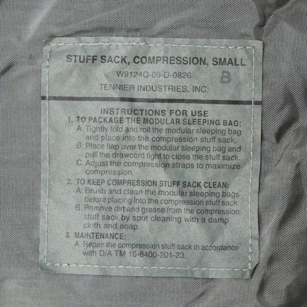 a foliage green US Army small compression stuff sack, part of the Improved Modular Sleep System (IMSS)