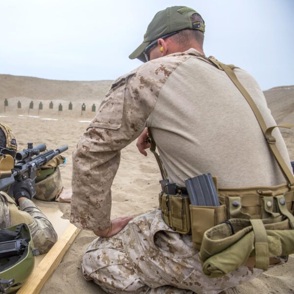 a US Marine wearing sub belt suspenders and a war belt