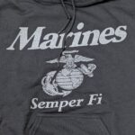 a black Marine Corps hoodie with reflective print: "Marines" "Semper Fi" and an Eagle, Globe, & Anchor