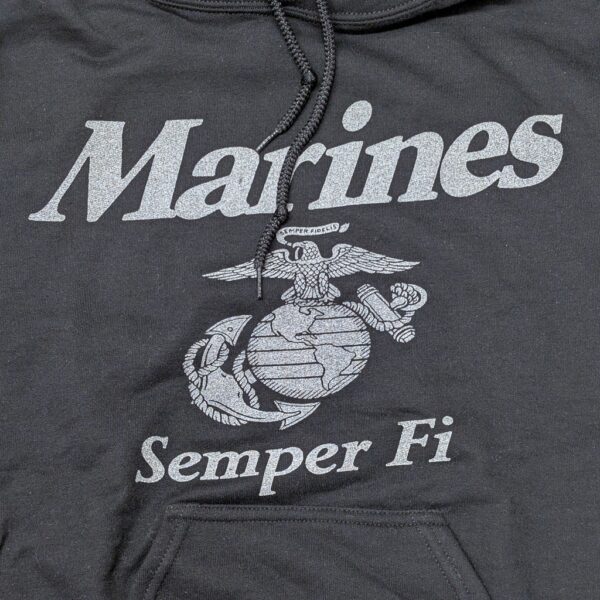 a black Marine Corps hoodie with reflective print: "Marines" "Semper Fi" and an Eagle, Globe, & Anchor