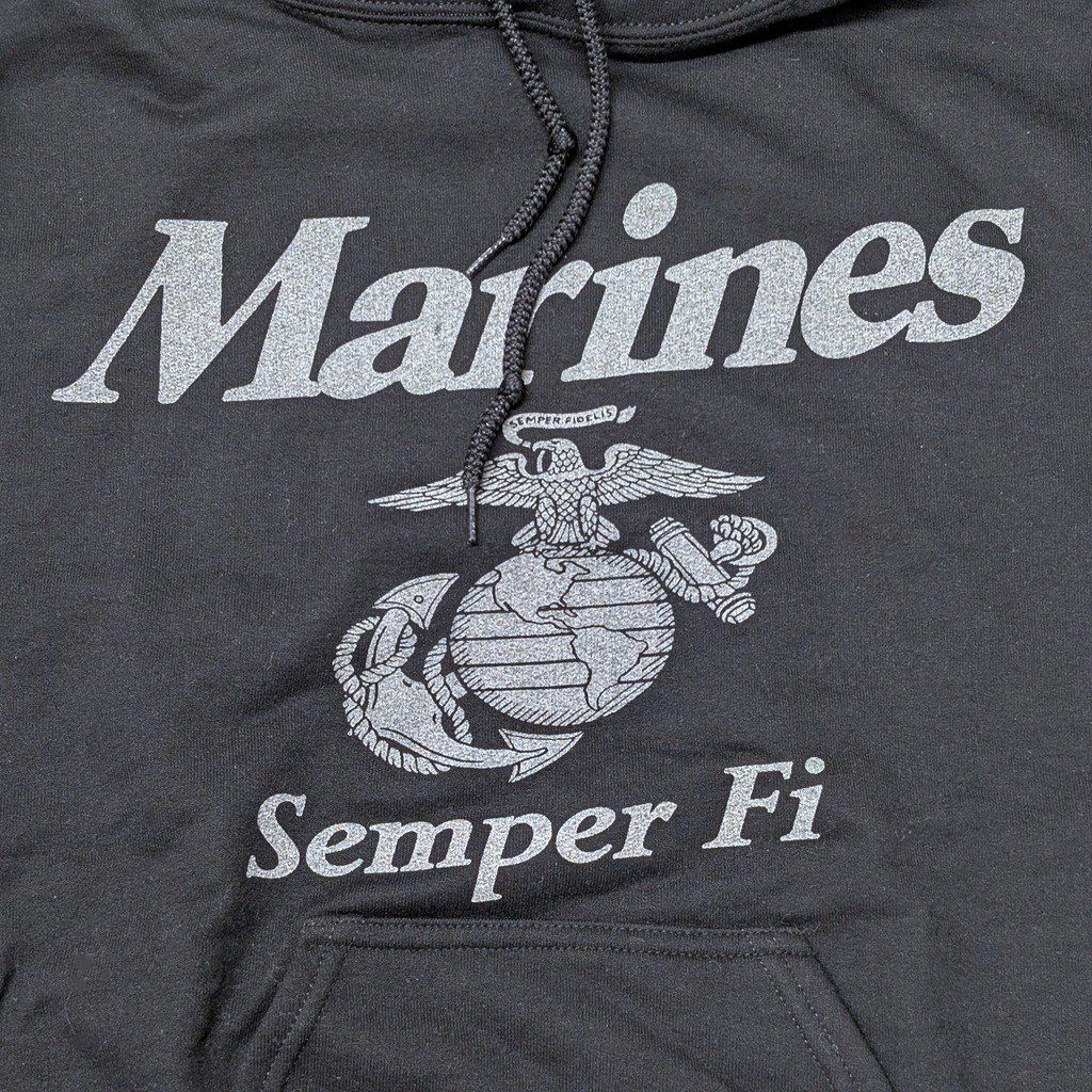 a black Marine Corps hoodie with reflective print: "Marines" "Semper Fi" and an Eagle, Globe, & Anchor